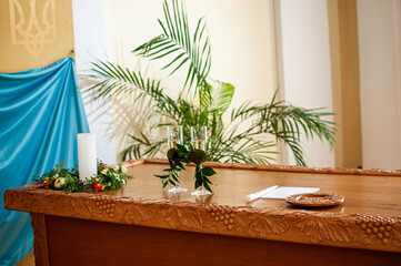 glasses of champagne are decorated with green branches on the table