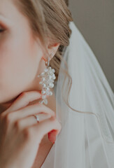 Beautiful bride with fashion wedding hairstyle. Closeup portrait of young gorgeous bride with veil.