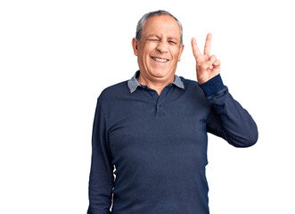 Senior handsome man wearing casual polo smiling with happy face winking at the camera doing victory sign. number two.