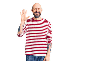 Fototapeta premium Young handsome man wearing casual clothes showing and pointing up with fingers number five while smiling confident and happy.