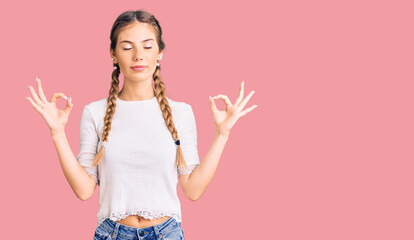 Beautiful caucasian woman with blonde hair wearing braids and white tshirt relax and smiling with eyes closed doing meditation gesture with fingers. yoga concept.