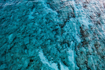 An aerial view of the beautiful Mediterranean sea, where you can se the rocky textured underwater corals and the clean turquoise water of Cyprus
