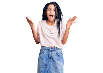 Obraz na płótnie Canvas Cute african american girl wearing casual clothes celebrating victory with happy smile and winner expression with raised hands