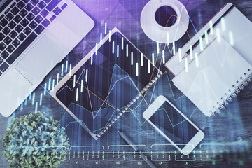Double exposure of forex chart hologram over desktop with phone. Top view. Mobile trade platform concept.