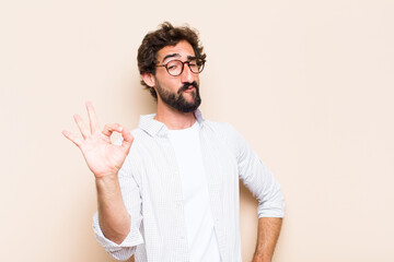 young cool bearded man with okay gesture and satisfied expressio