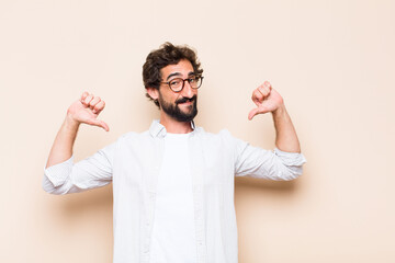 young cool bearded man with proud and satisfied expression
