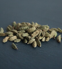 Green cardamon (Elettaria cardamomum), Cardamom pods on grey background