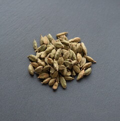 Green cardamon (Elettaria cardamomum), Cardamom pods on grey background