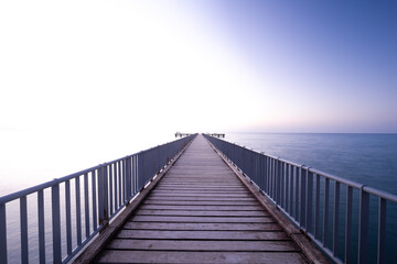wooden bridge, pier leading to the sea, with copy space above