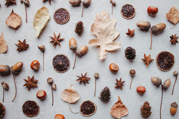 Autumn vibes. Pattern made of dried leaves, acorns and pine cones on white background. Seasonal background, fall concept, thanksgiving day composition. Flat lay, top view