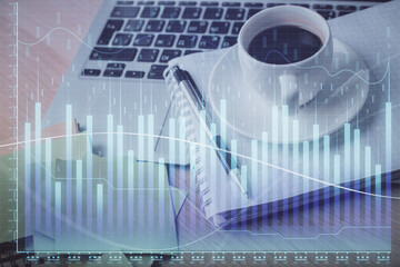 Double exposure of forex chart drawing and desktop with coffee and items on table background. Concept of financial market trading