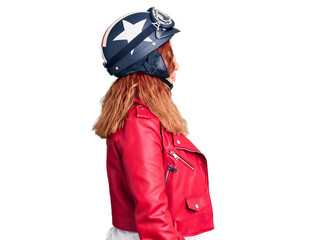 Young latin woman wearing leather jacket holding motorcycle helmet looking to side, relax profile pose with natural face with confident smile.