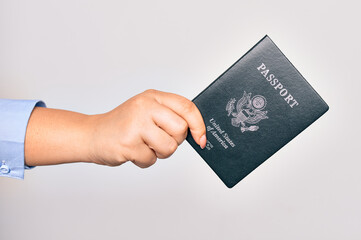 Hand of caucasian young woman holding united states passport document over isolated white background