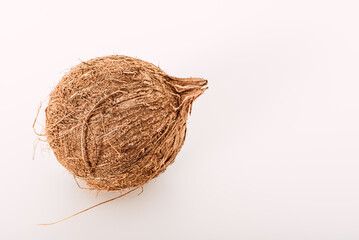 A fresh unopened coconut isolated on white background.
