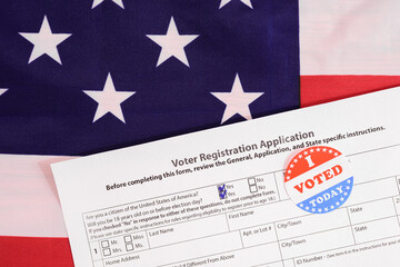 American citizens fill out the form to apply in the voting, on patriotic background of American flag.