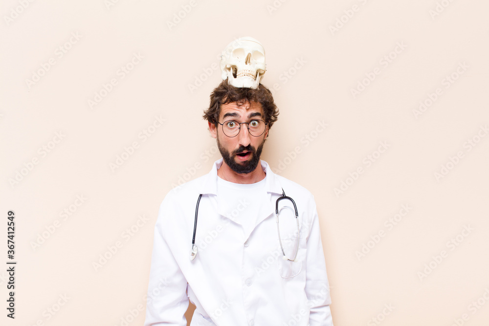 Wall mural young physician man with a skull on his head