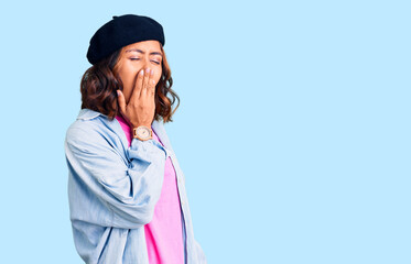 Young beautiful mixed race woman wearing french look with beret bored yawning tired covering mouth with hand. restless and sleepiness.