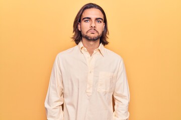 Young handsome man wearing business clothes depressed and worry for distress, crying angry and afraid. sad expression.