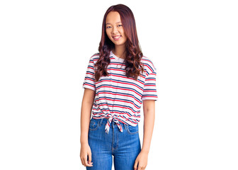 Fototapeta premium Young beautiful chinese girl wearing casual clothes looking positive and happy standing and smiling with a confident smile showing teeth