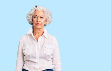 Senior grey-haired woman wearing casual clothes relaxed with serious expression on face. simple and natural looking at the camera.
