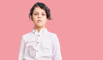 Cute hispanic child wearing casual clothes with serious expression on face. simple and natural...