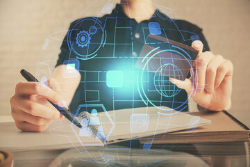 Double exposure of man hands holding a credit card and social network theme drawing. Digital finance and E-commerce concept.