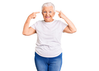 Senior beautiful woman with blue eyes and grey hair wearing casual white tshirt smiling pointing to head with both hands finger, great idea or thought, good memory