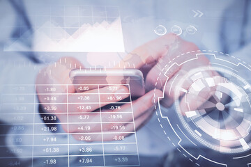 Double exposure of man's hands holding and using a digital device and forex graph drawing. Financial market concept.