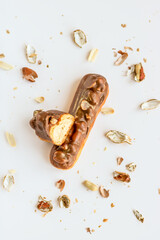 Selective focus on eclair with peanuts and cream.