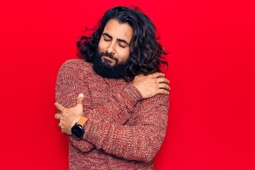 Young arab man wearing casual clothes hugging oneself happy and positive, smiling confident. self love and self care