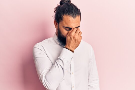 Young arab man wearing casual clothes tired rubbing nose and eyes feeling fatigue and headache. stress and frustration concept.
