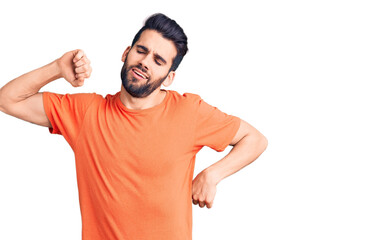 Fototapeta premium Young handsome man with beard wearing casual t-shirt stretching back, tired and relaxed, sleepy and yawning for early morning