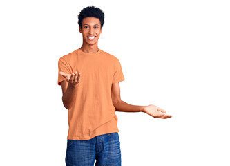 Young african american man wearing casual clothes smiling cheerful with open arms as friendly welcome, positive and confident greetings