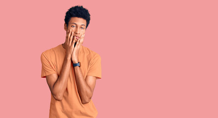 Young african american man wearing casual clothes tired hands covering face, depression and sadness, upset and irritated for problem