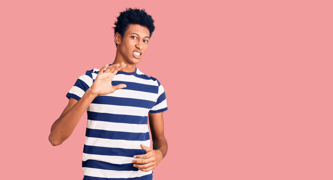 Young african american man wearing casual clothes disgusted expression, displeased and fearful doing disgust face because aversion reaction. with hands raised