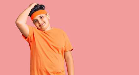 Little boy kid wearing sportswear smiling confident touching hair with hand up gesture, posing attractive and fashionable