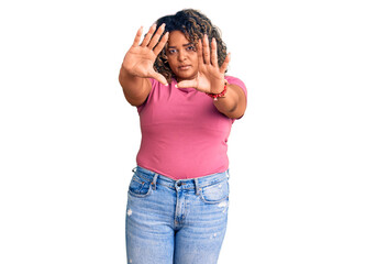 Young african american plus size woman wearing casual clothes doing frame using hands palms and fingers, camera perspective