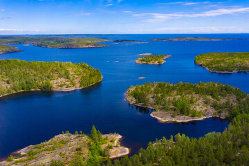 Aerial photography of the lake and Islands. A bird-eye view of the natural landscape. Lake and rocky Islands on a summer day. Wildlife. Natural landscape from the throne.