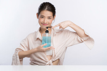 Young Asian Woman holding an alcohol gel bottle for advertising concept isolated on white background