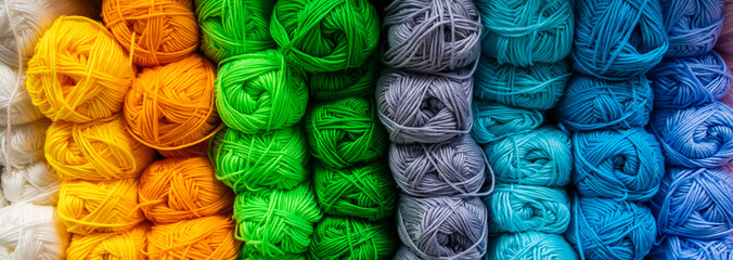 Many balls of wool yarn for knitting. Selling fluffy threads in a craft store
