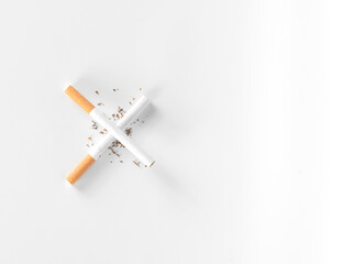 cigarettes lay as a cross sign in white background from top view with copy space.quit smoke , world tobacco concept.