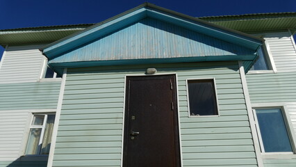 verandah of the house with an iron door