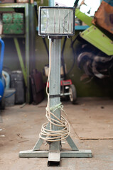 Homemade industrial spotlight made of metal profiles stands in the garage
