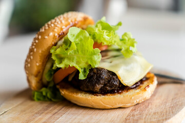 Hamburger on the wooden plate. Fast food concept