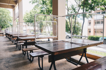 Group of plastic partition setting on table in canteen for reduce and protection the COVID-19 virus...