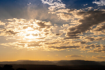 sunset in the sky in the sun behind the clouds