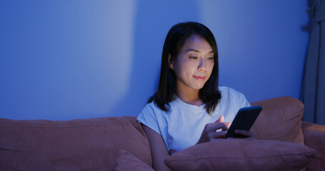 Woman use of smart phone at home in the evening