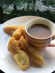 dough fried sticks with coffee on morning