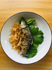 Grilled fish on a white plate background