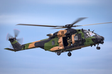Naklejka na ściany i meble Camouflaged army helicopter.